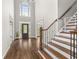 Elegant foyer with soaring ceilings, hardwood floors, staircase and front door with decorative glass insert at 4345 Mantle Ridge Dr, Cumming, GA 30041
