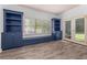 Living room with storage cabinets, a bench, large window, and wood-look floors at 4345 Mantle Ridge Dr, Cumming, GA 30041