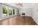 Bright living room with fireplace, hardwood floors, crown molding, ceiling fan and large windows at 4345 Mantle Ridge Dr, Cumming, GA 30041