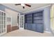 Cozy home office with built-in shelving, French doors, chair rail, and plantation shutters at 4345 Mantle Ridge Dr, Cumming, GA 30041