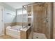 Bathroom featuring a soaking tub and glass-enclosed shower area at 506 Spring View Dr, Woodstock, GA 30188