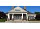 This clubhouse is a brick building with a covered entrance and beautiful surrounding landscaping at 506 Spring View Dr, Woodstock, GA 30188