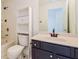 Bathroom featuring a vanity with dark cabinets, white sink and toilet, and a shower-tub combination at 5900 Fairington Farms Lane Ln, Stonecrest, GA 30038