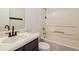 Bathroom featuring a white vanity with sink and a bathtub-shower with white tile surround and chrome fixtures at 5900 Fairington Farms Lane Ln, Stonecrest, GA 30038