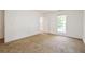 Bright bedroom with neutral carpet and natural light from the open window and white trim throughout at 5900 Fairington Farms Lane Ln, Stonecrest, GA 30038