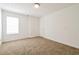Bright, carpeted bedroom with white walls, a window, and a door, offering a clean and spacious feel at 5900 Fairington Farms Lane Ln, Stonecrest, GA 30038