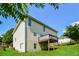 Exterior view of a two-story home with a deck, siding, green grass, and mature trees under a clear sky at 5900 Fairington Farms Lane Ln, Stonecrest, GA 30038