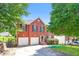Two-story brick home featuring a two-car garage, manicured lawn, and traditional curb appeal at 5900 Fairington Farms Lane Ln, Stonecrest, GA 30038