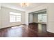 Bright living room with large windows, decorative molding, and dark wood-like floors at 5900 Fairington Farms Lane Ln, Stonecrest, GA 30038