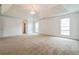 Large main bedroom features tray ceiling, chandelier, and natural light at 5900 Fairington Farms Lane Ln, Stonecrest, GA 30038