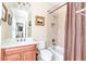Charming bathroom with vanity, toilet, shower with curtain, and neutral tile at 8095 Georgetown Cir, Suwanee, GA 30024