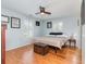 Bright bedroom features hardwood floors, ceiling fan, and bright light at 8095 Georgetown Cir, Suwanee, GA 30024
