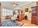 Charming bedroom with a canopy bed, hardwood floors, and plenty of natural light at 8095 Georgetown Cir, Suwanee, GA 30024