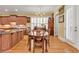 Elegant dining area with hardwood floors, chandelier, and ample natural light from large windows at 8095 Georgetown Cir, Suwanee, GA 30024