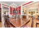 Elegant dining room with wood floors, a view into other rooms, and seating for eight at 8095 Georgetown Cir, Suwanee, GA 30024