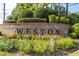 Welcoming 'Weston' community sign surrounded by vibrant flowerbeds and lush greenery at 8095 Georgetown Cir, Suwanee, GA 30024