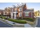 Charming red brick home boasts a classic design and beautifully landscaped front yard at 8095 Georgetown Cir, Suwanee, GA 30024