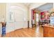 Bright entryway with a large front door, hardwood floors, and a view of the elegant dining room at 8095 Georgetown Cir, Suwanee, GA 30024