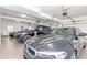 Garage featuring epoxy flooring, overhead lighting, and black BMW and Range Rover at 8095 Georgetown Cir, Suwanee, GA 30024