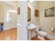Well-appointed half bathroom featuring a pedestal sink and elegant decor at 8095 Georgetown Cir, Suwanee, GA 30024