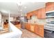Bright kitchen features granite counters, stainless appliances, and wood cabinets at 8095 Georgetown Cir, Suwanee, GA 30024
