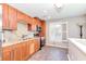 Bright kitchen features granite counters, stainless appliances, and wood cabinets at 8095 Georgetown Cir, Suwanee, GA 30024