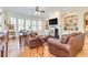 Bright living room featuring a fireplace, custom built-ins, and comfortable leather seating at 8095 Georgetown Cir, Suwanee, GA 30024