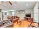 Cozy living room features hardwood floors and bright light at 8095 Georgetown Cir, Suwanee, GA 30024