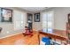 Bright bonus room features hardwood floors, exercise equipment, and bright light at 8095 Georgetown Cir, Suwanee, GA 30024
