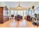 Spacious office with hardwood floors, lots of display cabinets, and bright natural lighting from a bay window at 8095 Georgetown Cir, Suwanee, GA 30024