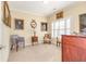 Cozy sitting room with comfortable seating, decorative paintings, and natural light from the window at 8095 Georgetown Cir, Suwanee, GA 30024