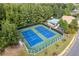 Aerial view of community tennis courts, surrounded by lush trees, near pool and clubhouse at 8095 Georgetown Cir, Suwanee, GA 30024
