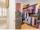 Spacious walk-in closet with custom shelving, clothes hanging, and bathroom nearby at 8095 Georgetown Cir, Suwanee, GA 30024