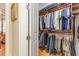 Walk-in closet featuring custom shelving, clothes hanging, and ample storage space at 8095 Georgetown Cir, Suwanee, GA 30024