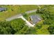 Aerial view of a well-maintained home featuring lush trees, greenery, and a paved driveway at 1480 Bettis Tribble Gap Rd, Cumming, GA 30040