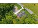 Aerial view of a well-maintained home with a gray roof, surrounded by lush greenery and a paved driveway at 1480 Bettis Tribble Gap Rd, Cumming, GA 30040