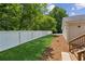 Fenced backyard with green grass with landscaped beds ready for entertaining at 1480 Bettis Tribble Gap Rd, Cumming, GA 30040