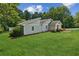 Well-maintained home on a large lot featuring lush green grass and healthy trees at 1480 Bettis Tribble Gap Rd, Cumming, GA 30040