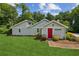 Attractive one-story home featuring a well-manicured lawn and inviting landscaping at 1480 Bettis Tribble Gap Rd, Cumming, GA 30040