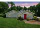 Charming single-story home with a well-maintained lawn and a vibrant red front door at 1480 Bettis Tribble Gap Rd, Cumming, GA 30040