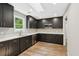 Spacious kitchen featuring dark cabinets, stainless steel appliances, and quartz countertops at 1480 Bettis Tribble Gap Rd, Cumming, GA 30040