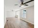 Bright living room featuring contemporary ceiling fans and beautiful wood-look floors at 1480 Bettis Tribble Gap Rd, Cumming, GA 30040