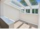 Bright sunroom featuring a skylight, hardwood floors, and white walls at 1480 Bettis Tribble Gap Rd, Cumming, GA 30040