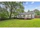 Expansive backyard featuring a deck, lush lawn, and mature trees, perfect for outdoor enjoyment at 1617 Columbia Cir, Decatur, GA 30032