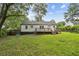 Large backyard with a wooden deck, lush lawn, and mature trees providing a serene outdoor space at 1617 Columbia Cir, Decatur, GA 30032