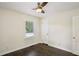 Cozy bedroom showcasing hardwood floors, neutral walls, and natural light from the window at 1617 Columbia Cir, Decatur, GA 30032