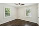 Bright bedroom features hardwood floors, two windows offering natural light, and neutral paint at 1617 Columbia Cir, Decatur, GA 30032
