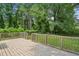 Wooden deck provides an inviting outdoor space with views of the lush, green backyard at 1617 Columbia Cir, Decatur, GA 30032