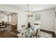 A bright dining room featuring hardwood floors, a chandelier, and connecting living space at 1617 Columbia Cir, Decatur, GA 30032
