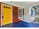 Charming front porch with a porch swing and a cheerful yellow front door at 1617 Columbia Cir, Decatur, GA 30032